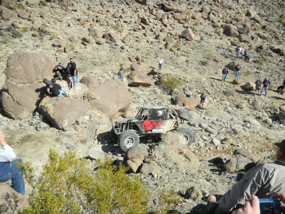 Off-road buggy with skull decal climbing rocky terrain
