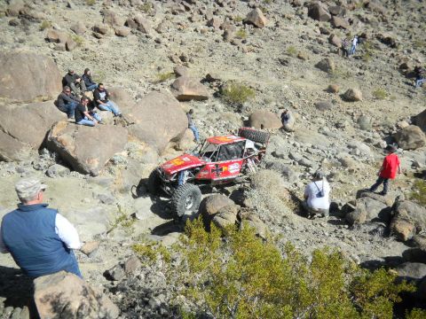 1997 Ford Ranger - Off-road buggy navigates a steep, rocky course with onlookers observing the action.