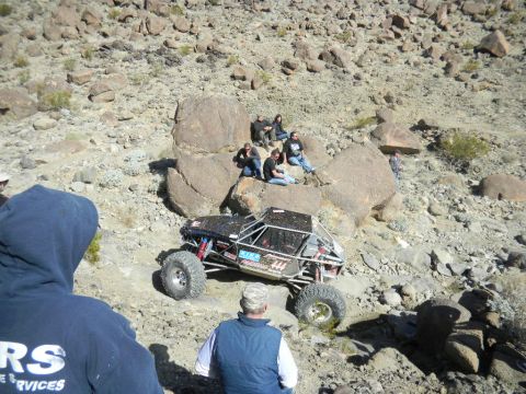 1997 Ford Ranger - Spectators watch an off-road buggy tackle a challenging rocky course during a race event.