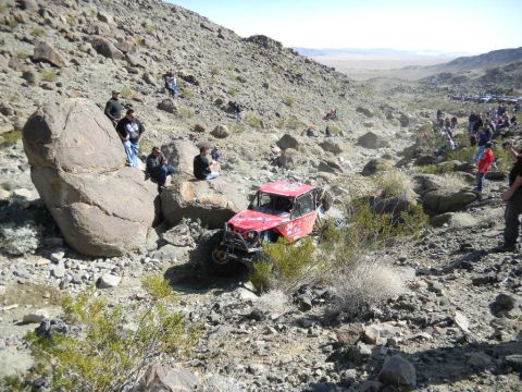 1997 Ford Ranger - Off-road buggy navigating a steep, rocky course with spectators on the slopes.