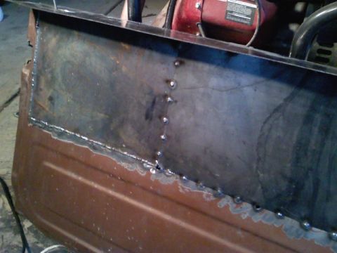 1990 Ford Bronco - Close-up of a welded metal panel, indicating repair or modification work on a vehicle part.