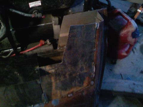 1990 Ford Bronco - Custom metal fabrication is visible in the engine bay, alongside a red fluid container.