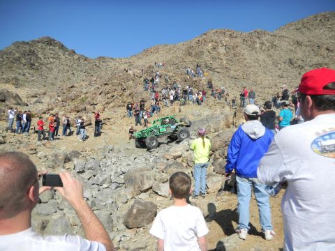 1997 Ford Ranger - Spectators watch an off-road buggy navigate a challenging rocky incline during a race event.