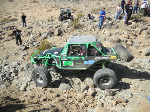 1997 Ford Ranger - Custom off-road buggy navigates a rocky trail with spectators watching.