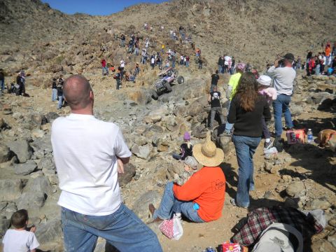 1997 Ford Ranger - Spectators watch an off-road vehicle navigate a steep, rocky incline during an event.