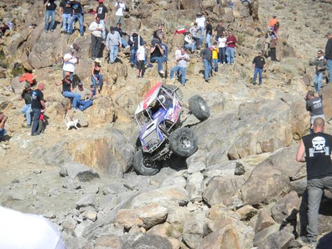 1997 Ford Ranger - A custom-built rock crawling buggy navigates a challenging, steep, rocky incline with onlookers observing the event.