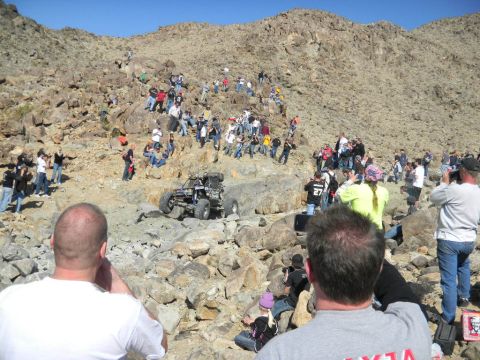 1997 Ford Ranger - Spectators gather to watch an off-road buggy tackle a challenging rocky terrain during an event.