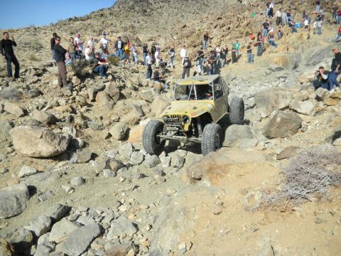 1997 Ford Ranger - A custom-built buggy navigates a rocky desert course with a crowd observing the event.