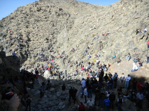 1997 Ford Ranger - A large crowd of people are watching an event from a rocky hillside.