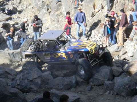 1997 Ford Ranger - A custom off-road buggy tackles a challenging rocky course, cheered on by onlookers.