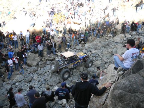 1997 Ford Ranger - Spectators watch an off-road buggy tackle a challenging rocky course during an event.