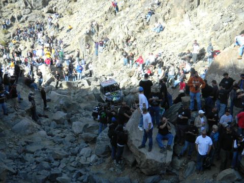 1997 Ford Ranger - Spectators gather to watch an off-road buggy tackle a challenging rocky terrain during an event.