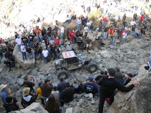 1997 Ford Ranger - A crowd watches an off-road buggy with Monster Energy sponsorship navigate a challenging rocky course.