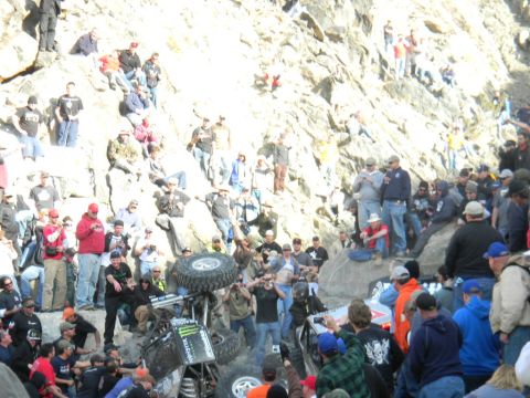 1997 Ford Ranger - A crowd gathers to watch an off-road buggy that has overturned on a steep, rocky incline.