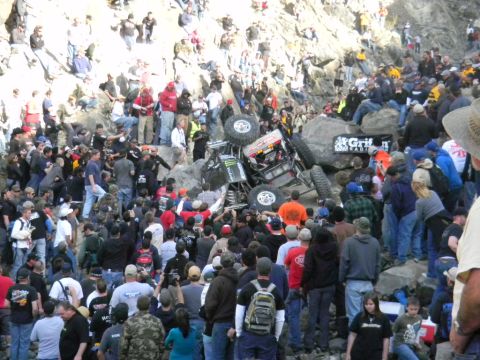 1997 Ford Ranger - A crowd gathers to watch an off-road buggy navigate a rocky obstacle during a race event.