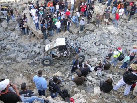 1997 Ford Ranger - A crowd watches an off-road buggy crawl over a treacherous, rocky terrain during an event.