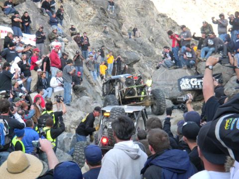 1997 Ford Ranger - Spectators gather to watch an off-road buggy tackle a challenging rocky terrain during an event.
