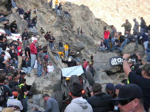 1997 Ford Ranger - Spectators gather to watch an off-road vehicle tackle a challenging rocky incline during an event.