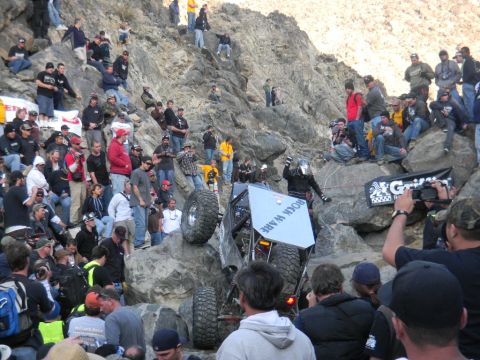 1997 Ford Ranger - Spectators watch an off-road vehicle navigate a challenging rocky terrain during a competition.