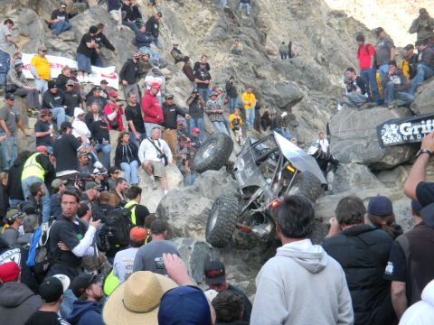1997 Ford Ranger - A custom off-road buggy navigates a challenging rocky terrain during a race event, drawing a large crowd of spectators.