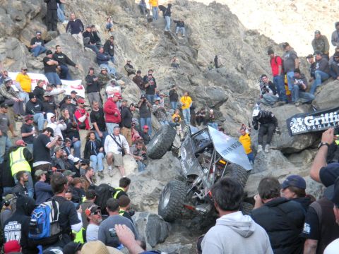 1997 Ford Ranger - Spectators watch an off-road vehicle navigate a rocky incline during a race event.