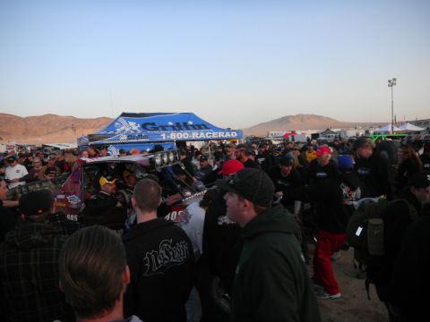 1997 Ford Ranger - A large crowd surrounds off-road vehicles at an event, with a sponsor tent visible in the background.