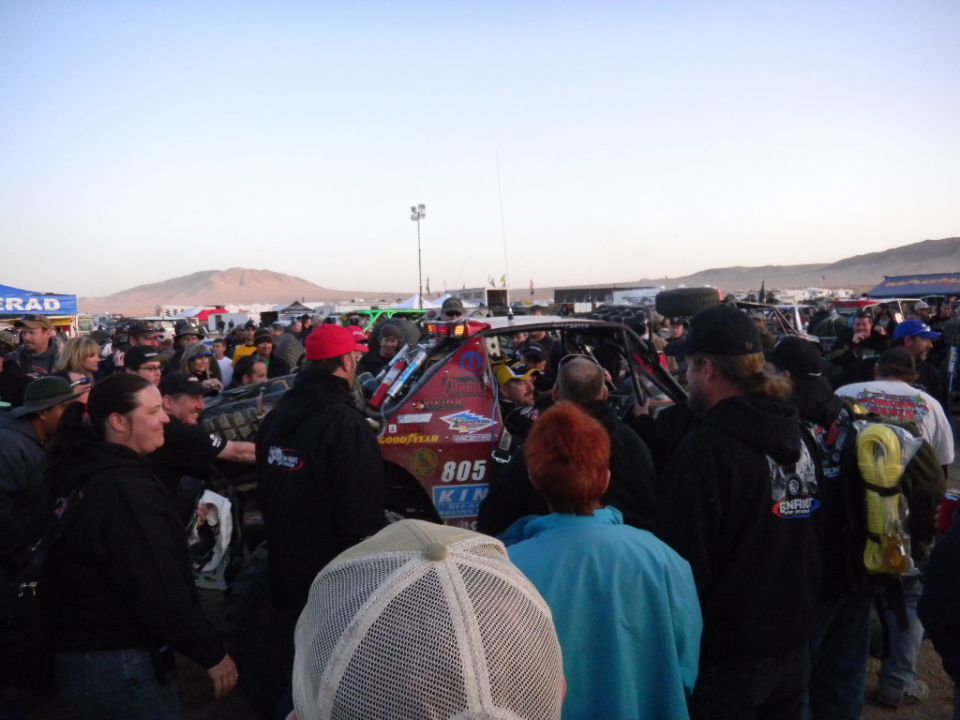 Off-road race truck with number 805, surrounded by a crowd