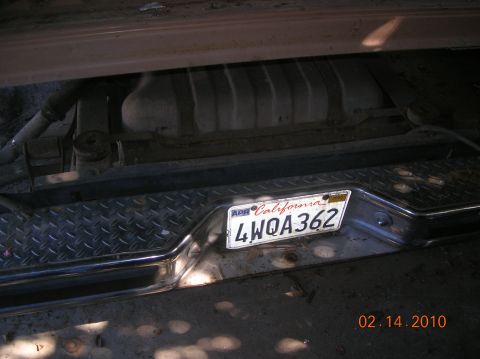1985 Ford Bronco - Rear view of a vehicle showing a diamond plate bumper and California license plate.
