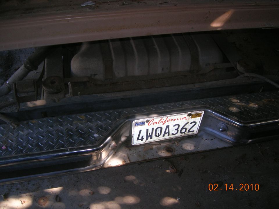 Diamond plate bumper with California license plate 4WQA362 and visible fuel tank