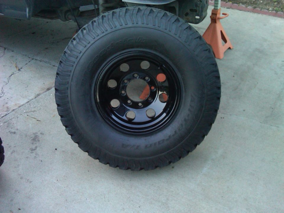 Black tire and wheel assembly on concrete