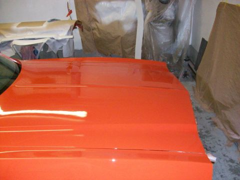 1973 Ford Ranchero - The bright orange paint on this car's hood shows off its smooth finish and subtle body lines.