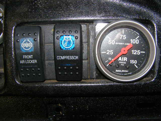 Dashboard interior with 'FRONT AIR LOCKER' and 'COMPRESSOR' switches and an Auto Meter air pressure gauge
