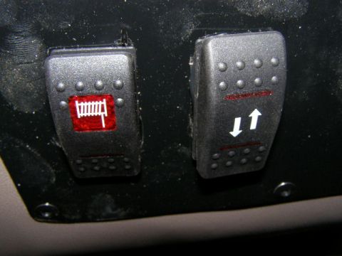 1993 Ford Bronco - Aftermarket switches with icons for a fence and directional arrows are installed in the vehicle's interior.