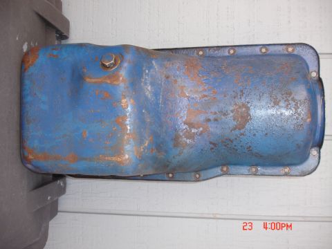 1978 Ford Mustang II - This is a blue oil pan with visible rust and a bolt on top.