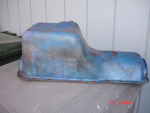 1978 Ford Mustang II - A blue oil pan with visible rust and wear is shown against a white paneled background.
