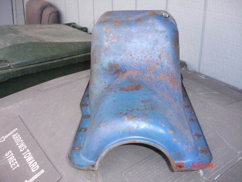 1978 Ford Mustang II - Oil pan with visible rust and blue paint. Signage indicates "ARROWS TOWARD STREET".