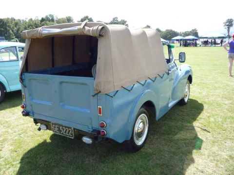 1969 MINI Cooper - A light blue pickup truck with a tan canvas top is parked on a grassy field.