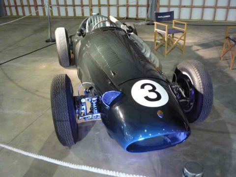 1969 MINI Cooper - A dark blue racing car with a prominent white number 3 on its nose is displayed indoors.