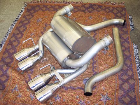 2006 Chevrolet Corvette - This exhaust system features quad exhaust tips and dual mufflers, laid out on a patterned rug.
