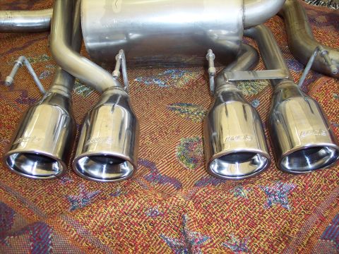 2006 Chevrolet Corvette - Four chrome Borla exhaust mufflers are shown, likely for a performance vehicle.