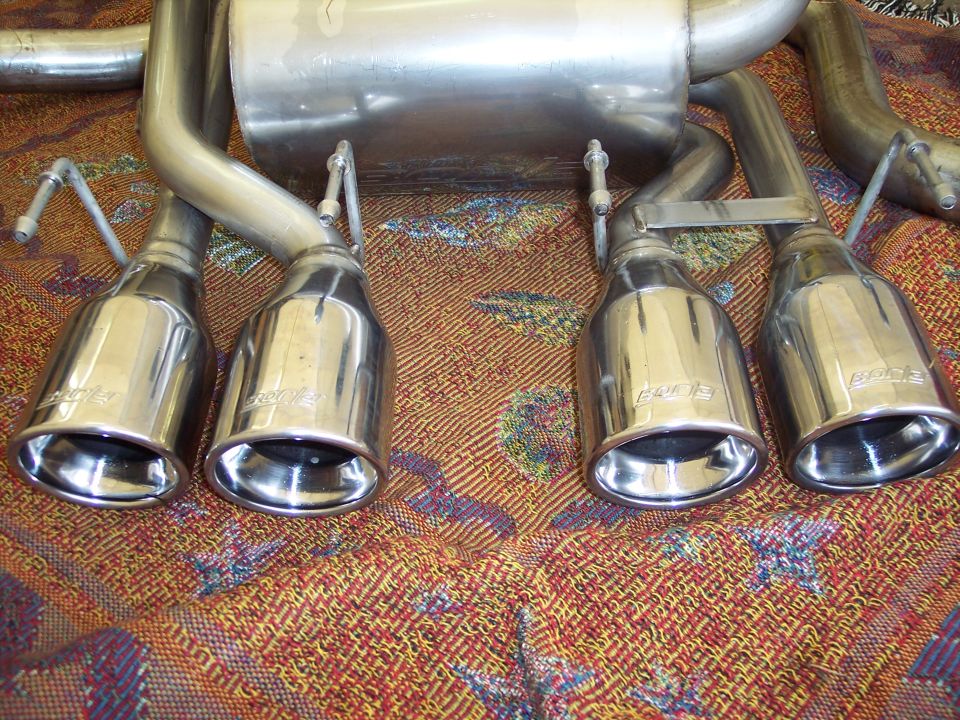 Four chrome exhaust mufflers with 'Borla' branding