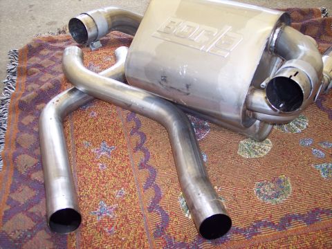 2006 Chevrolet Corvette - Borla exhaust system components shown on a rug, not installed on a vehicle.