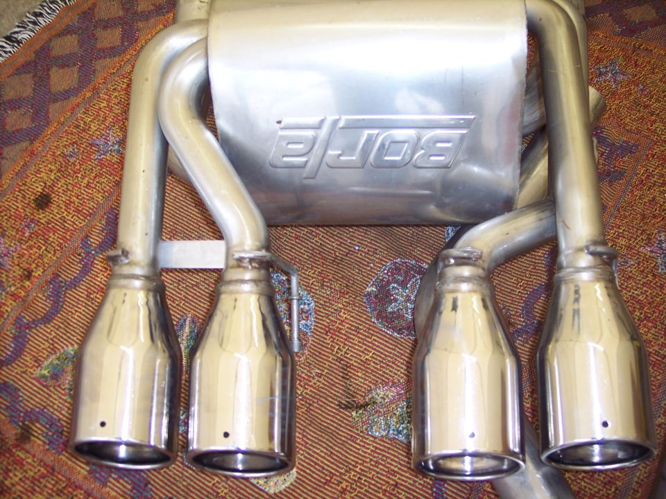 Borla mufflers with four chrome exhaust tips, sitting on a patterned rug