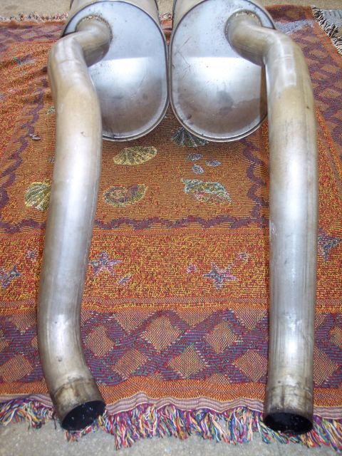 2006 Chevrolet Corvette - Pair of exhaust mufflers with curved pipes, likely for a performance vehicle.