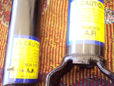 2006 Chevrolet Corvette - Close-up of two shock absorbers, one with a visible part number and manufacturing information.