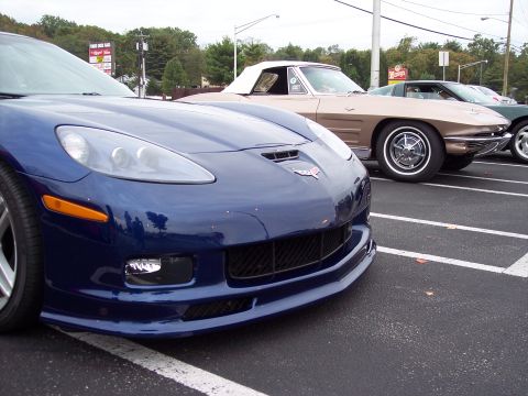 2006 Chevrolet Corvette - Front view of a blue 2006 Chevrolet Corvette parked in a lot with other Corvettes.