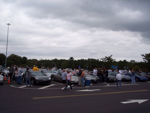 2006 Chevrolet Corvette - A gathering of Chevrolet Corvettes in a parking lot.