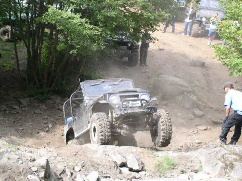 1979 Ford Bronco - Jeep Wrangler tackling a challenging off-road course.