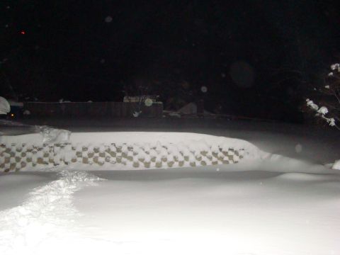 1948 Jeep Wrangler - Nighttime scene with snow covering the ground and a low wall.