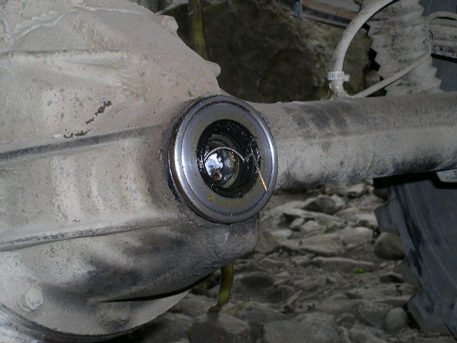 close up of a vehicle's differential axle housing with a bearing visible